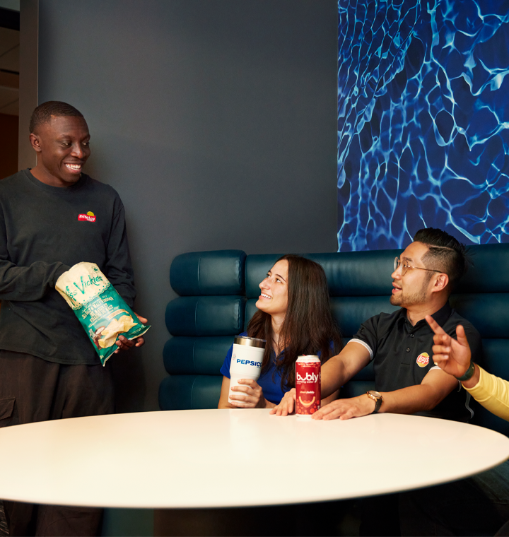 Employees enjoying PepsiCo products around a table